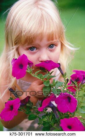 little girl smelling flowers View Large Photo Image Stock Image - little girl smelling flowers. Fotosearch