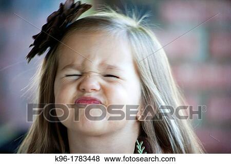 Stock Photo - little girl squishing her face to be funny. Fotosearch