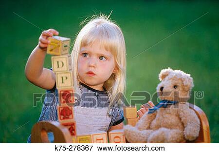 Little girl stacking up blocks View Large Photo Image Stock Photo - Little girl stacking up blocks. Fotosearch