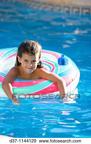 little girl swimming in a swimming pool with a rubber ring View Large Photo Image Stock Photo - little girl swimming in a swimming pool with a rubber ring. Fotosearch