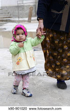 Little girl walking with her grandmother hand in hand, Ichon_Qala (Old Town), Khiva, Uzbekistan, Central Asia View Large Photo Image Stock Image - Little girl walking with her grandmother hand in hand, Ichon_Qala (Old Town), Khiva, Uzbekistan, Central Asia. Fotosearch