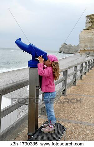 little girl watching with a telescope, Etretat, Cote d? Albatre, Pays de Caux, Seine-Maritime department, Upper Normandy region, France, Europe View Large Photo Image Stock Photography - little girl watching with a telescope, Etretat, Cote d? Albatre, Pays de Caux, Seine-Maritime department, Upper Normandy region, France, Europe. Fotosearch