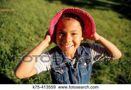 Stock Photo - Little girl wearing hat and a big smile. Fotosearch