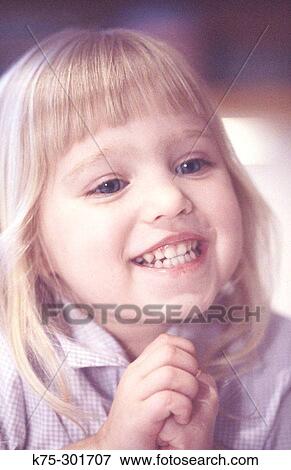 Stock Photo - little girl with a big grin. Fotosearch