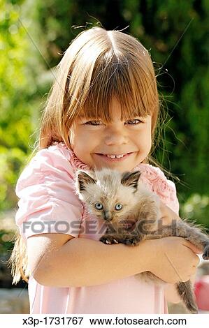 Little girl with a kitten View Large Photo Image Stock Photo - Little girl with a kitten. Fotosearch