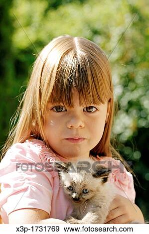 Little girl with a kitten View Large Photo Image Stock Photo - Little girl with a kitten. Fotosearch