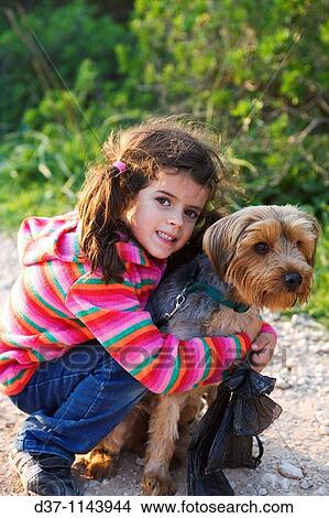 Little girl with a Yorkshire Terrier dog View Large Photo Image Picture - Little girl with a Yorkshire Terrier dog. Fotosearch