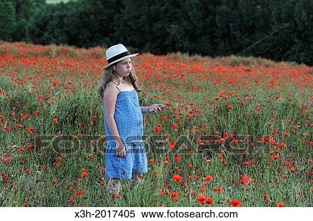 little girl with blue dress and a panama hat listening music in a poppies field, Eure et Loir department, region Centre, France, Europe. View Large Photo Image Stock Photography - little girl with blue dress and a panama hat listening music in a poppies field, Eure et Loir department, region Centre, France, Europe.. Fotosearch