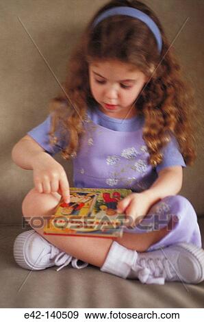 Stock Photo - Little girl with book. Fotosearch