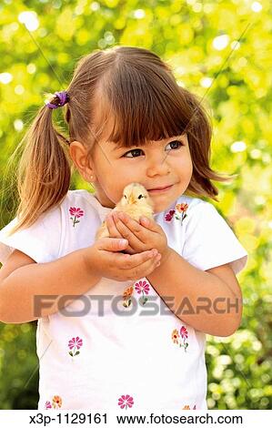 Little girl with chick View Large Photo Image Stock Image - Little girl with chick. Fotosearch