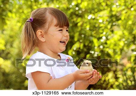 Stock Photography - Little girl with chick. Fotosearch