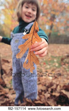 Picture - Little girl with leaf. Fotosearch