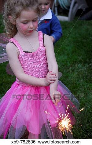 Little girl with sparkler View Large Photo Image Stock Photograph - Little girl with sparkler. Fotosearch