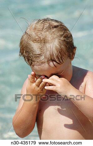 Little girl with water in her eyes View Large Photo Image Stock Photo - Little girl with water in her eyes. Fotosearch