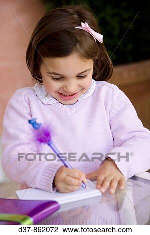 Little girl writing on a notebook View Large Photo Image Stock Image - Little girl writing on a notebook. Fotosearch