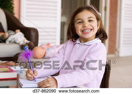 Little girl writing on a notebook View Large Photo Image Stock Image - Little girl writing on a notebook. Fotosearch