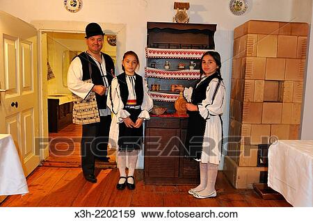 little girls and their father in traditional costume at a restaurant with locals in the village of Sibiel, department of Sibiu, Transylvania, Romania, Southeastern and Central Europe. View Large Photo Image Stock Photo - little girls and their father in traditional costume at a restaurant with locals in the village of Sibiel, department of Sibiu, Transylvania, Romania, Southeastern and Central Europe.. Fotosearch