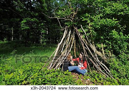 little girls beside a wood hut in the forest at the Rochers d'Angennes site, Forest of Rambouillet, departement of Yvelines, Ile de France region, France, Europe. View Large Photo Image Picture - little girls beside a wood hut in the forest at the Rochers d'Angennes site, Forest of Rambouillet, departement of Yvelines, Ile de France region, France, Europe.. Fotosearch