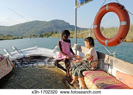 little girls during a boat trip on the channel of Dalyan, Turkey, Eurasia View Large Photo Image Stock Image - little girls during a boat trip on the channel of Dalyan, Turkey, Eurasia. Fotosearch