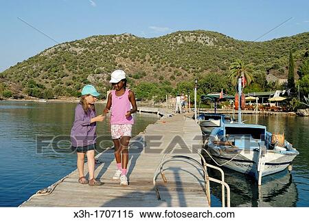 little girls on a footbridge in a creek of the Fethiye's bay, Lycian coast, Turkey, Eurasia View Large Photo Image Stock Photography - little girls on a footbridge in a creek of the Fethiye's bay, Lycian coast, Turkey, Eurasia. Fotosearch