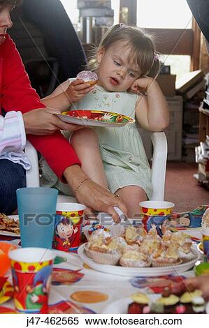 Little girl's third birthday party, a little girl looking fed up at the sight of all the food. View Large Photo Image Stock Photography - Little girl's third birthday party, a little girl looking fed up at the sight of all the food.. Fotosearch