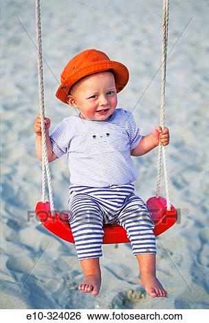 Little one year old boy on swing View Large Photo Image Stock Photograph - Little one year old boy on swing. Fotosearch