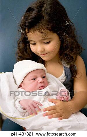 Little sister with newborn baby View Large Photo Image Stock Image - Little sister with newborn baby. Fotosearch