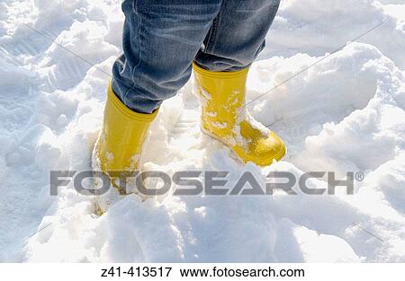 Little yellow boots in the snow View Large Photo Image Stock Photo - Little yellow boots in the snow. Fotosearch