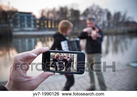 Live music of a violin and accordion duo on the banks of the canal in L? beck. Lubeck, Schleswig-Holstein, Germany. View Large Photo Image Stock Photograph - Live music of a violin and accordion duo on the banks of the canal in L? beck. Lubeck, Schleswig-Holstein, Germany.. Fotosearch