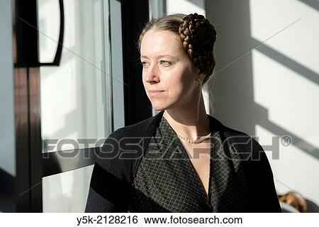 Living room or salon of studio apartment, Eindhoven, Netherlands. Young, attractive woman with tresses and tails in her hear, wearing a pearl neckless inherited from her grandmother. View Large Photo Image Stock Photograph - Living room or salon of studio apartment, Eindhoven, Netherlands. Young, attractive woman with tresses and tails in her hear, wearing a pearl neckless inherited from her grandmother.. Fotosearch