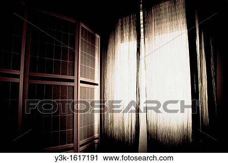 Living room with wooden folded screen and a window with black curtains with light coming in, Valencia, Spain View Large Photo Image Stock Image - Living room with wooden folded screen and a window with black curtains with light coming in, Valencia, Spain. Fotosearch