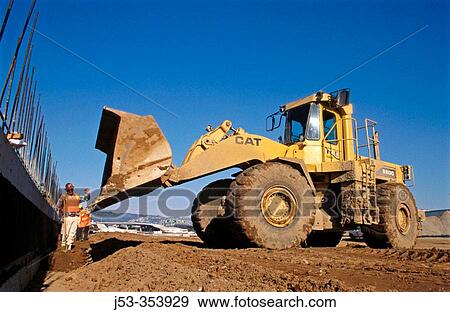 Stock Photo - Loader backfilling wall. I-880 Cypress project. Oakland, California. USA.. Fotosearch