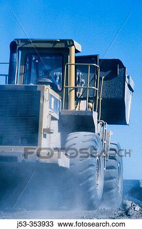 Stock Image - Loader in motion. I-880 Cypress Project. Oakland, California. USA.. Fotosearch