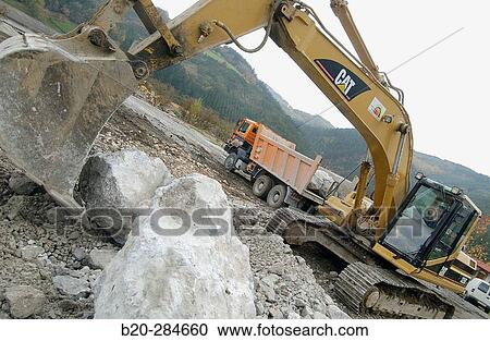 Loading rocks at quarry for construction of breakwater View Large Photo Image Stock Image - Loading rocks at quarry for construction of breakwater. Fotosearch