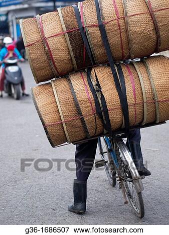 Loads piled up on bicycles for delivery in Hue, Vietnam View Large Photo Image Stock Photo - Loads piled up on bicycles for delivery in Hue, Vietnam. Fotosearch