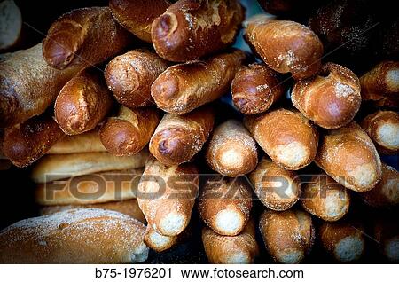 Stock Image - loaves and baguettes piled in a bakery. Fotosearch