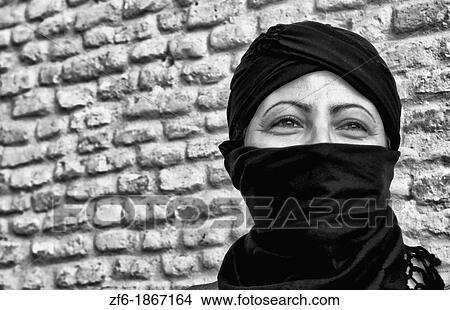Local Arab woman in veil against sand wall in Tuzeur in Sahara area of Tunisia in Africa View Large Photo Image Picture - Local Arab woman in veil against sand wall in Tuzeur in Sahara area of Tunisia in Africa. Fotosearch