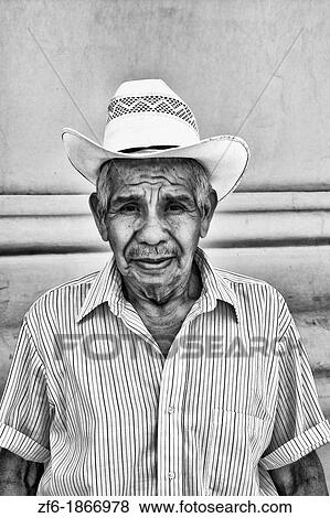Local colorful man against bright wall with cowboy hat in tourist village of Antigua Guatemala View Large Photo Image Stock Photo - Local colorful man against bright wall with cowboy hat in tourist village of Antigua Guatemala. Fotosearch