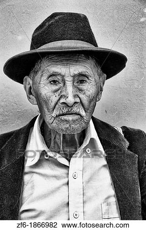 Local colorful old man with wrinkles and great eyes against bright wall with black cowboy hat in tourist village of Antigua Guatemala View Large Photo Image Stock Image - Local colorful old man with wrinkles and great eyes against bright wall with black cowboy hat in tourist village of Antigua Guatemala. Fotosearch
