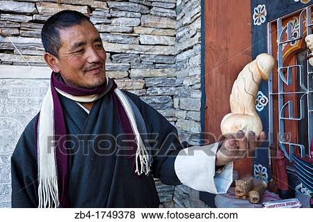Local craftsman with a phalluses made of wood that are meant in Bhutan fertility and protection to the family from evil, Thimphu, Bhutan, Asia. View Large Photo Image Stock Photo - Local craftsman with a phalluses made of wood that are meant in Bhutan fertility and protection to the family from evil, Thimphu, Bhutan, Asia.. Fotosearch
