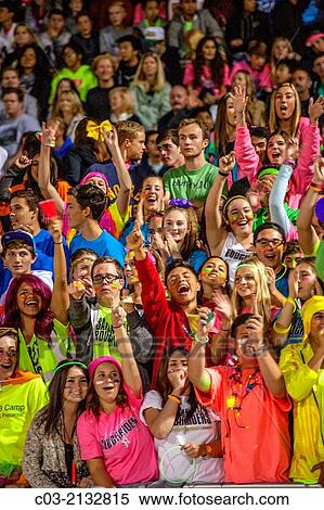 Local fans cheer their home team during a high school night football game in San Juan Capistrano, CA. View Large Photo Image Stock Photography - Local fans cheer their home team during a high school night football game in San Juan Capistrano, CA.. Fotosearch
