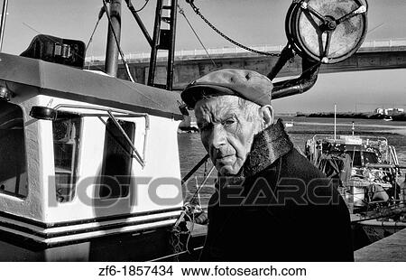 Picture - Local fisherman at boat in small village of Tivira in the Portugal Algarve coast. Fotosearch