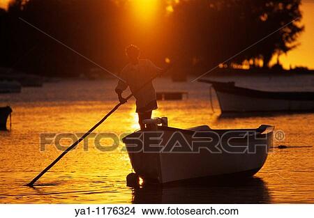 Local fisherman on his boat at sunset, Cape Malheureux, Mauritius Island, Indian Ocean View Large Photo Image Picture - Local fisherman on his boat at sunset, Cape Malheureux, Mauritius Island, Indian Ocean. Fotosearch