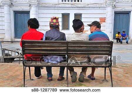 Stock Photo - Local friends talking together. Dabali Square, Basantapur, Nepal.. Fotosearch