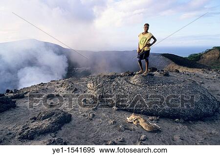 Local guide standing up on a freshly dropped lava bomb near the crater, Yasur Volcano, Sulphur Bay, Tanna Island, Vanuatu View Large Photo Image Stock Photography - Local guide standing up on a freshly dropped lava bomb near the crater, Yasur Volcano, Sulphur Bay, Tanna Island, Vanuatu. Fotosearch