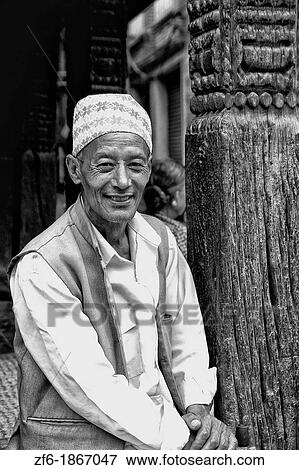 Local Hindu working man resting near street in village of Bhaktapur a town near Kathmandu Nepal View Large Photo Image Stock Photo - Local Hindu working man resting near street in village of Bhaktapur a town near Kathmandu Nepal. Fotosearch