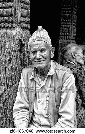 Local Hindu working man resting near street in village of Bhaktapur a town near Kathmandu Nepal View Large Photo Image Stock Photo - Local Hindu working man resting near street in village of Bhaktapur a town near Kathmandu Nepal. Fotosearch