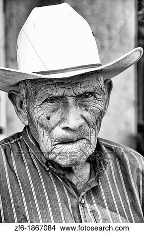 Local humble poor man portrait with cowboy hat in Lake Atitlan village of San Pedro Guatemala in Central America View Large Photo Image Picture - Local humble poor man portrait with cowboy hat in Lake Atitlan village of San Pedro Guatemala in Central America. Fotosearch