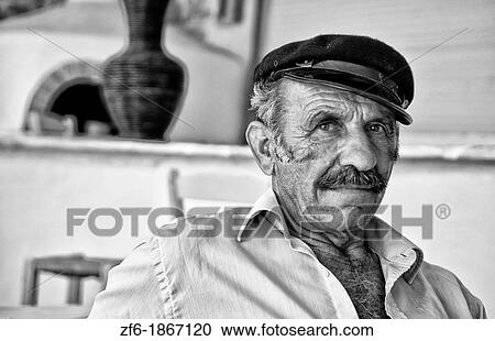 Local man portrait with Greek hat at restuarant in white in Mykonos in Greek Islands in Greece Europe View Large Photo Image Stock Image - Local man portrait with Greek hat at restuarant in white in Mykonos in Greek Islands in Greece Europe. Fotosearch