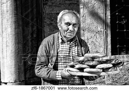 Stock Image - Local man selling bread with colorful scene in Istanbul Turkey. Fotosearch
